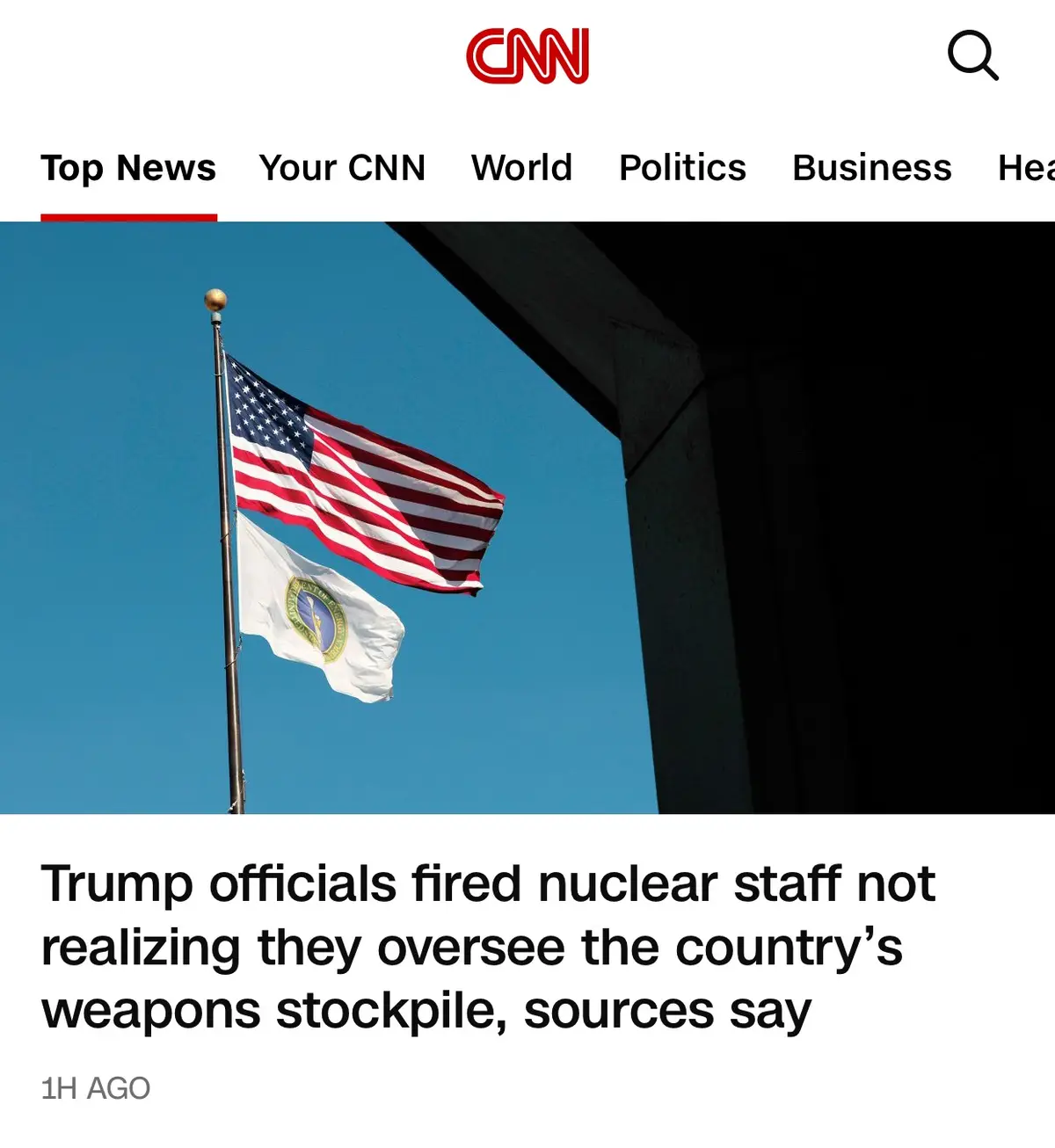 A screenshot of a CNN news article header showing two flags — the American flag and a white flag with a seal — waving…
