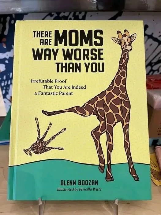 A book cover with a yellow background and teal bottom border, featuring a cartoon giraffe kicking another giraffe, which is…