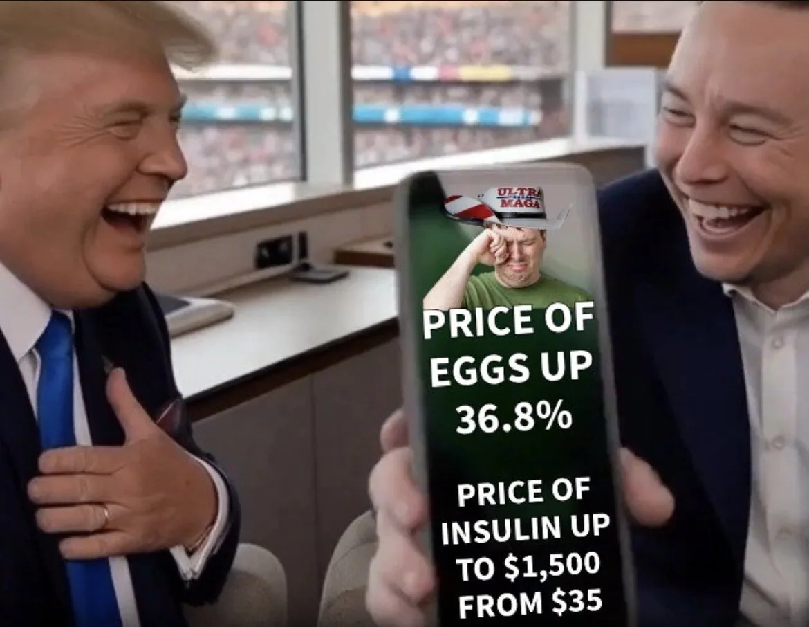 Two men, Donald Trump and Elon Musk, are laughing while looking at a smartphone screen. The phone displays a meme image of a…