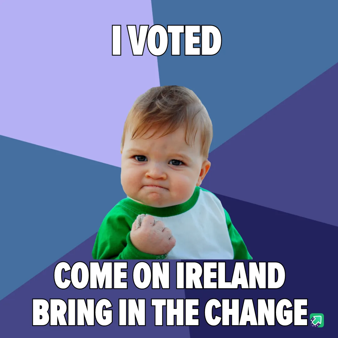 A baby with a determined, slightly smug expression, wearing a green and white shirt, clenched fist raised, set against a…
