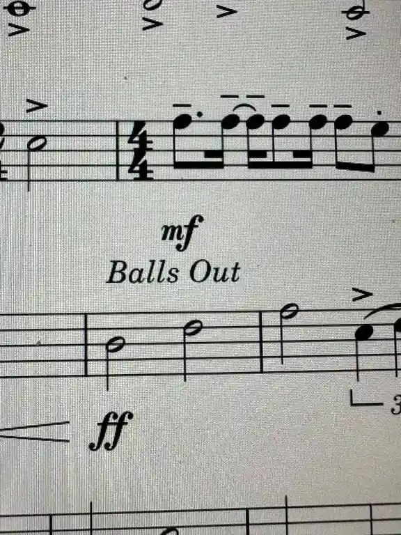 A close-up of sheet music showing standard musical notation with dynamic markings like 'mf' and 'ff'. Overlaid on the staff…