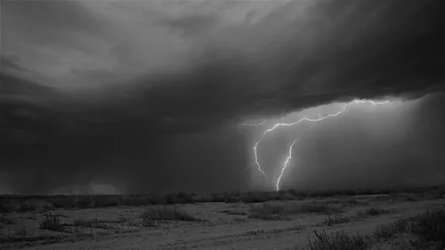 A black-and-white photo sequence shows a desert landscape under a stormy sky, with lightning bolts striking in the first…