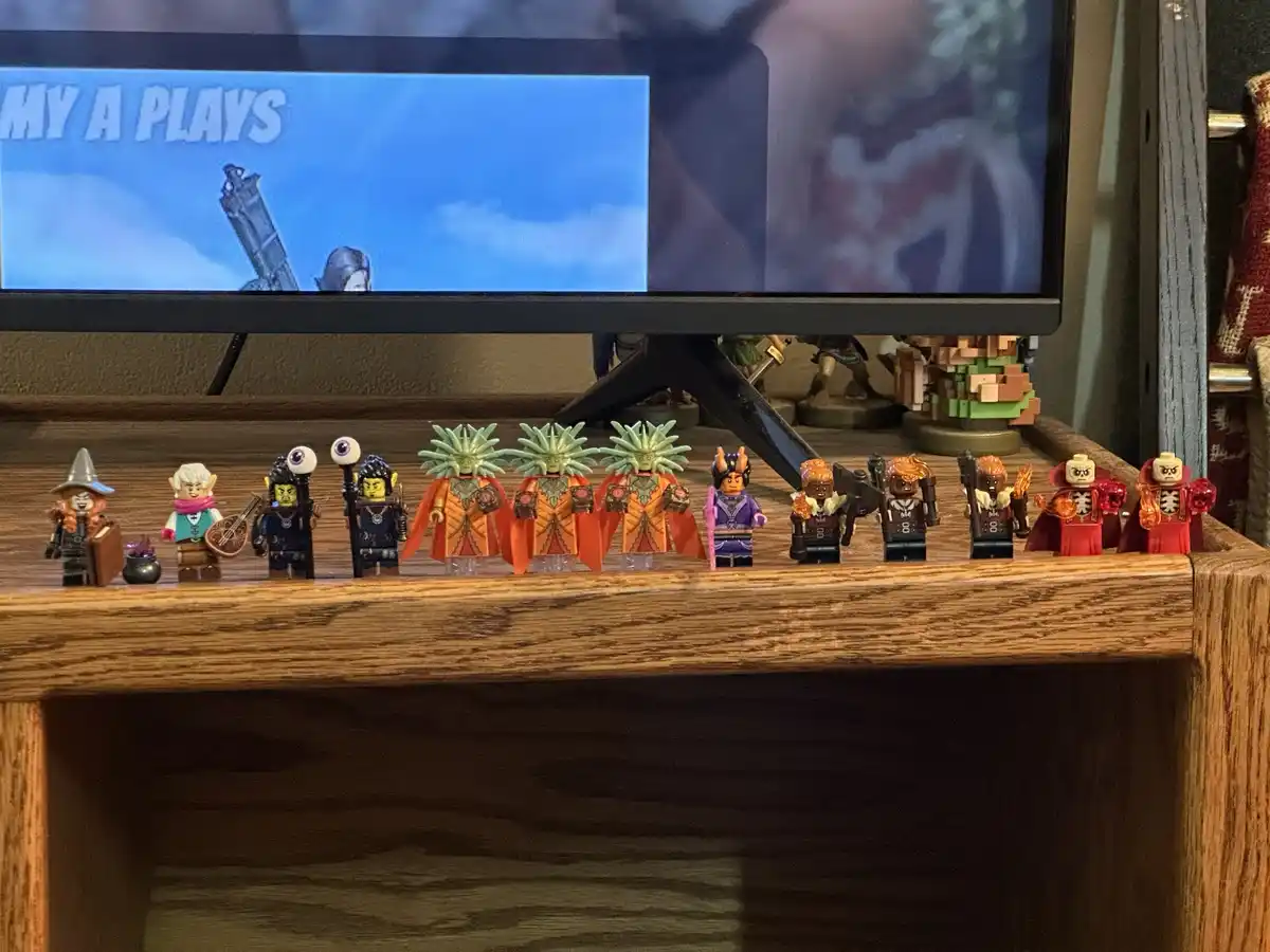 A row of colorful LEGO minifigures representing fantasy characters, including wizards, elves, and skeletons, are lined up on…