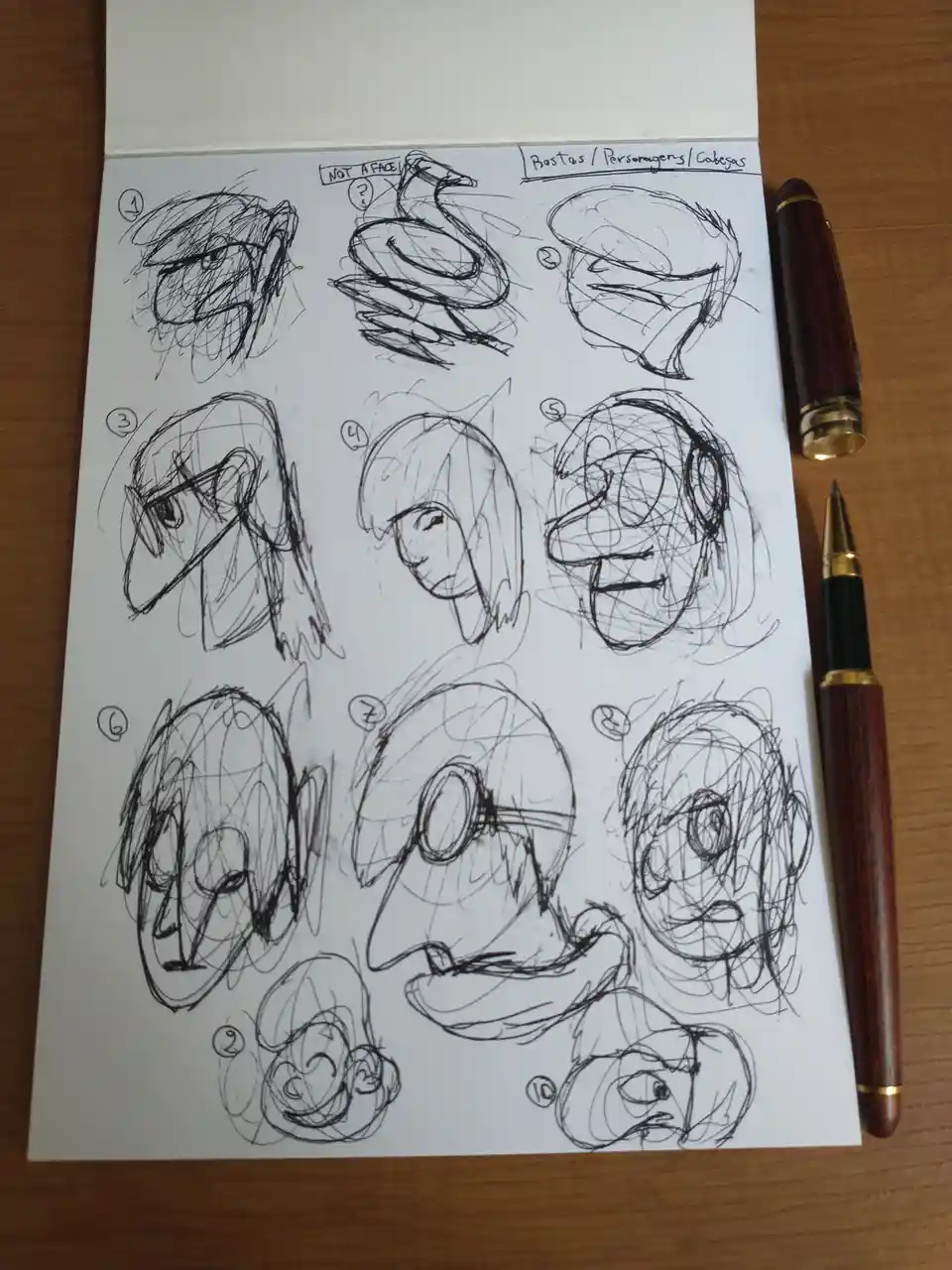 A sketchbook page displays ten潦草的 character head studies, numbered 1 through 10, with one labeled 'NOT A FACE' and another…