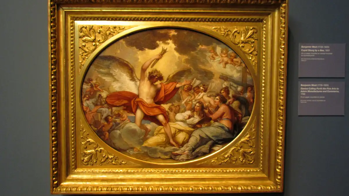 A classical painting in a gilded frame depicts a winged, laurel-crowned figure holding a laurel wreath, surrounded by…