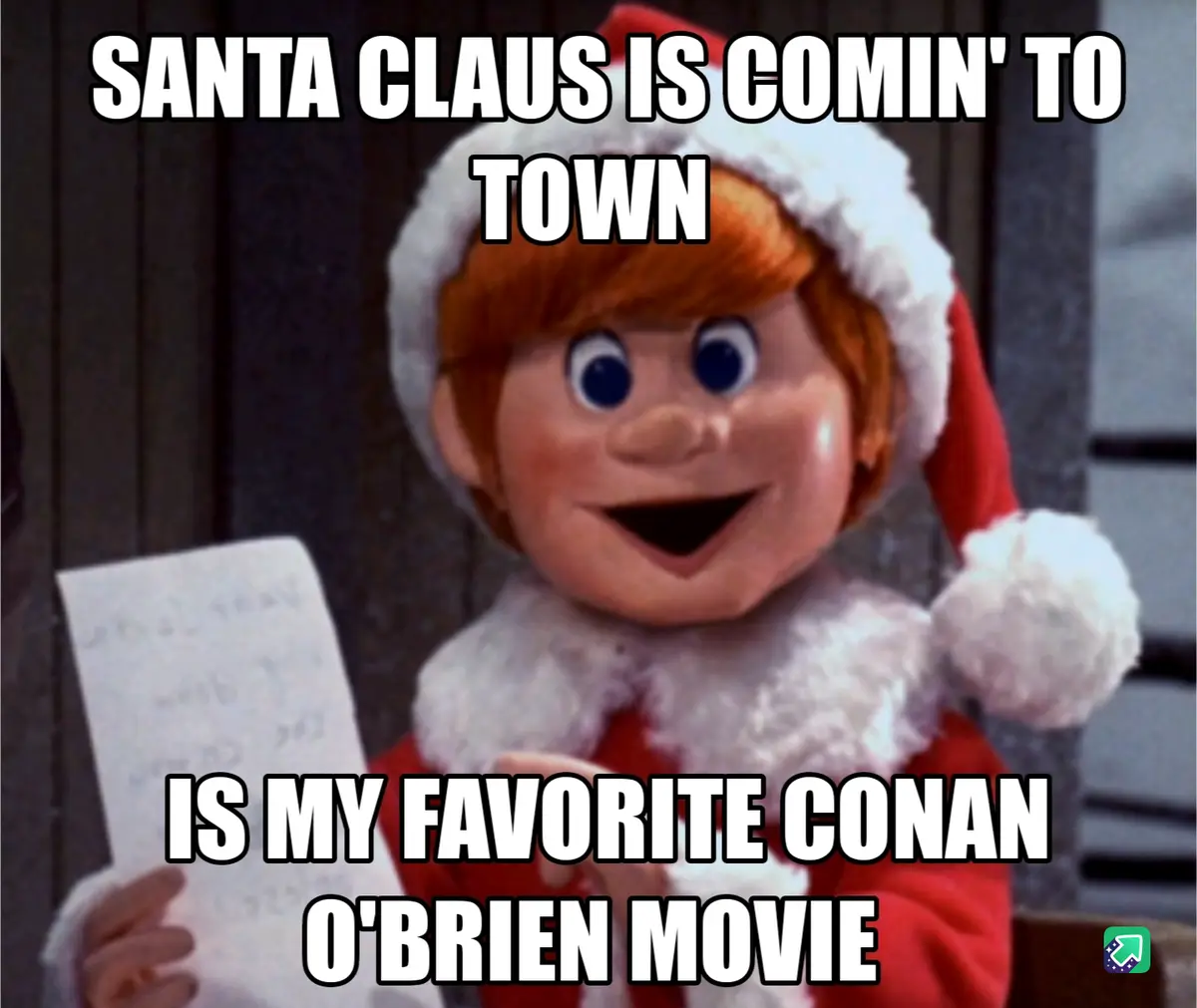 A puppet of a child in a red Santa hat and suit holds a piece of paper while looking excited. The text overlaid on the image…