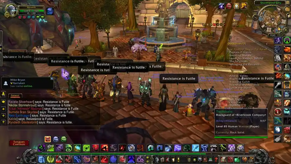 A screenshot from the MMORPG World of Warcraft shows a group of player characters gathered in Stormwind City. Multiple chat…