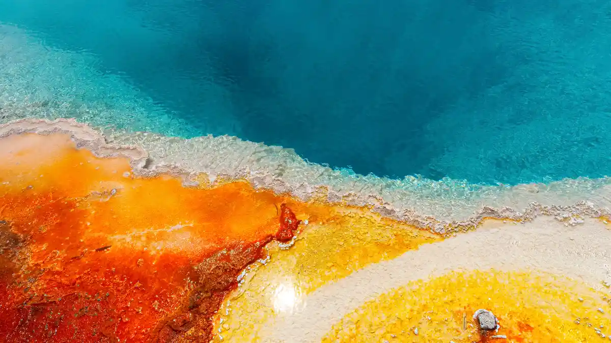Norris Geyser Basin, easily accessed by sturdy boardwalks, showcases Yellowstone's geothermal wonders. Vibrant blue-hot…