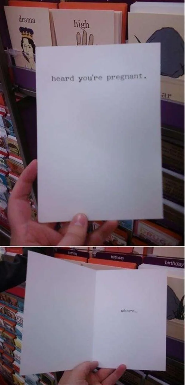 A hand holds a plain white greeting card in a store aisle with other greeting cards visible in the background. The front of…