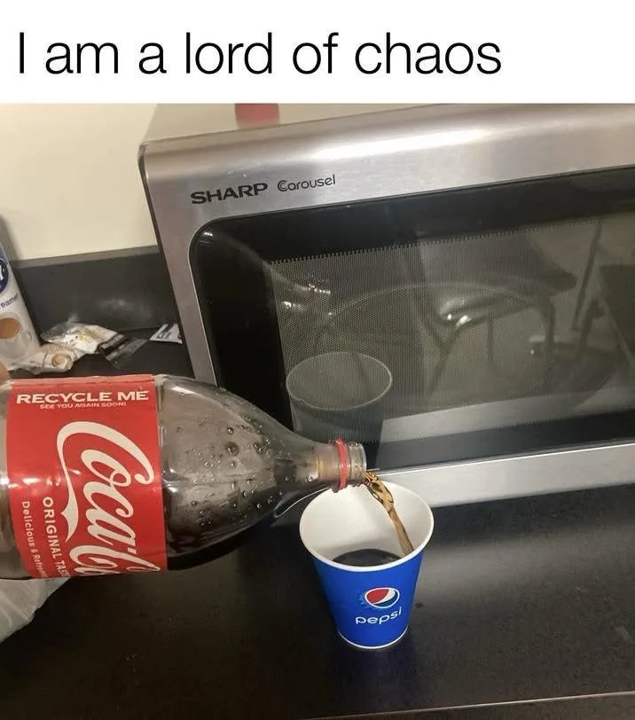 A bottle of Coca-Cola is being poured into a blue Pepsi-branded paper cup, which sits on a kitchen counter in front of a…