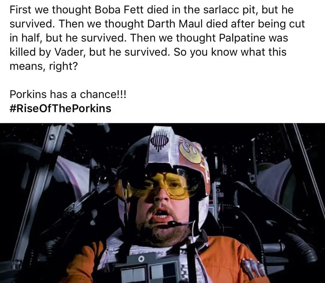 The image shows a man in an orange flight suit and helmet, seated in a cockpit with stars visible outside, looking shocked…