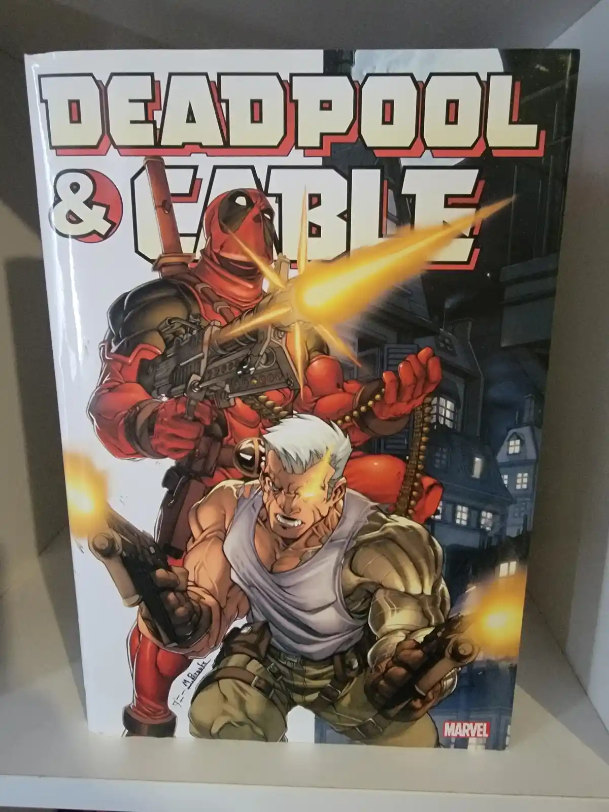 A comic book cover featuring Deadpool in red and black with a large weapon firing, standing behind Cable who has white hair…
