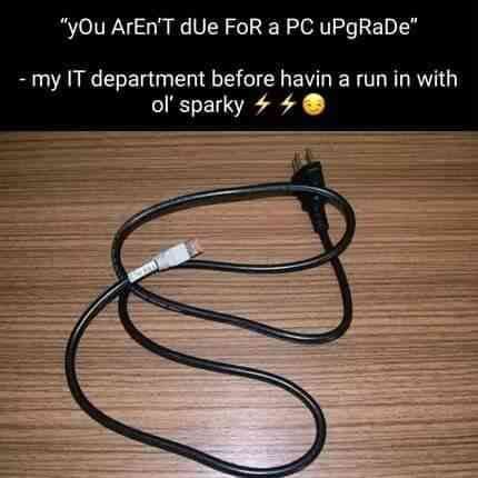 A black electrical cord with a plug and a USB connector lies coiled on a wooden surface. Overlaid text reads: 'yOu ArEn'T…
