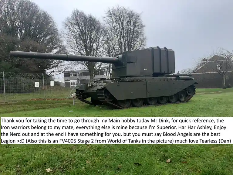 A large, olive-green military tank, identified as an FV4005 Stage 2 from World of Tanks, is parked on a grassy field with…