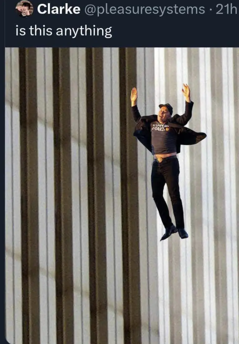 A man appears to be floating or levitating in mid-air against a background of vertical metal siding, with his arms raised…