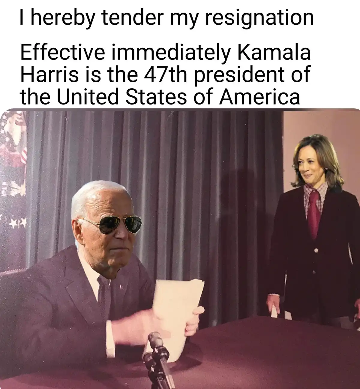 A man in a suit and sunglasses sits at a desk holding a paper, appearing to resign, while Kamala Harris stands beside him in…