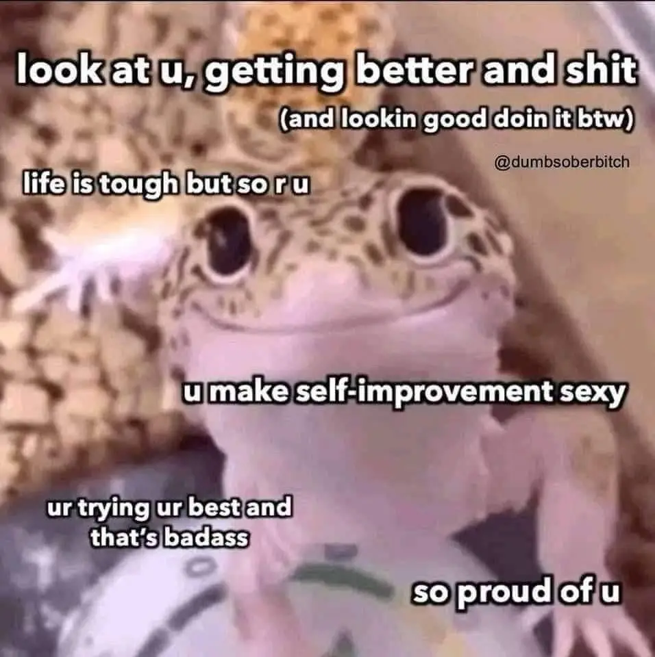 A close-up photo of a leopard gecko with large, expressive eyes and a slightly open mouth, looking directly at the camera…