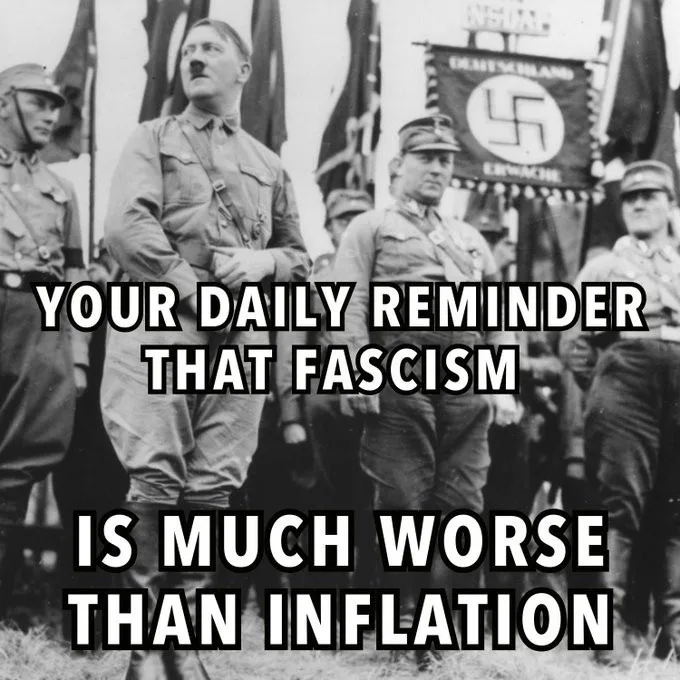 A black-and-white historical photograph shows Adolf Hitler standing among Nazi officials and flags, including a banner with…