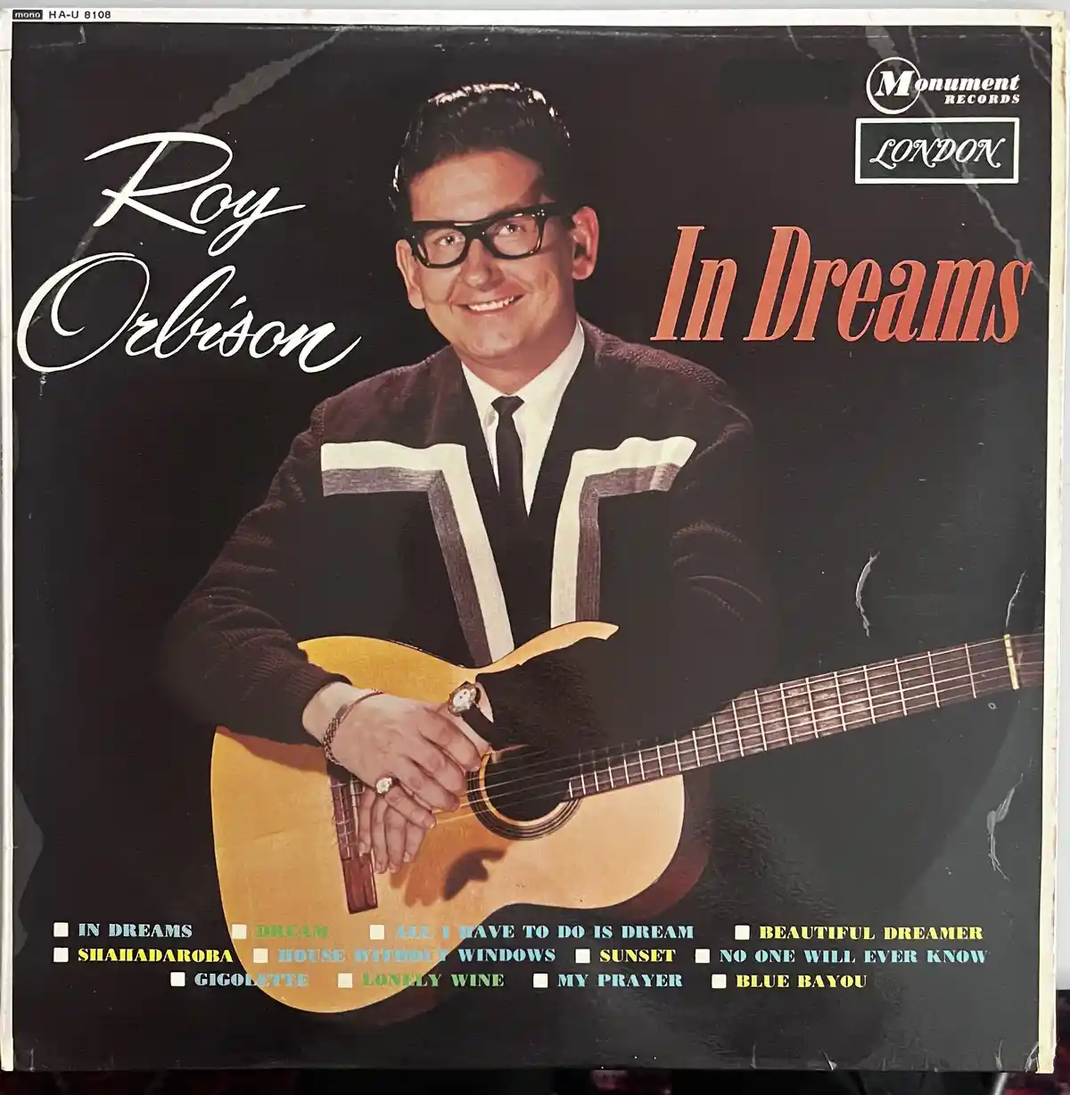 This is the album cover for Roy Orbison's 1961 LP 'In Dreams,' showing him smiling while holding an acoustic guitar. The…