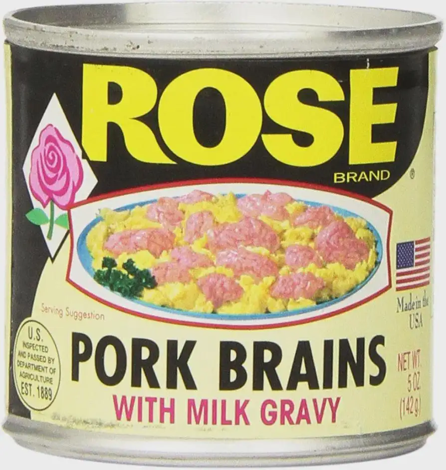 A can of Rose Brand food labeled 'Pork Brains with Milk Gravy' shows a serving suggestion of pink brain-like pieces over…