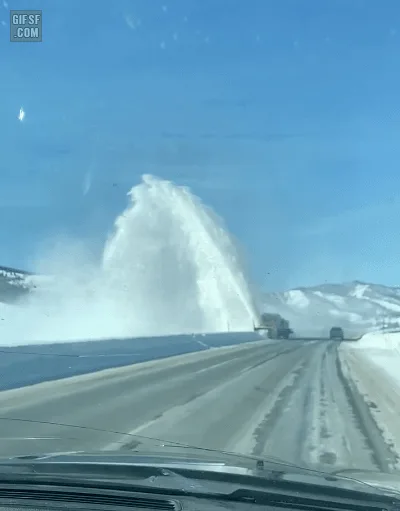 A sequence of six images shows a yellow snowplow truck from a car's dashboard view, blasting snow high into the air in a…