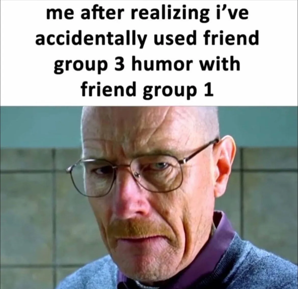 The image shows a close-up of Walter White from Breaking Bad, wearing glasses and a purple shirt under a grey sweater, with…
