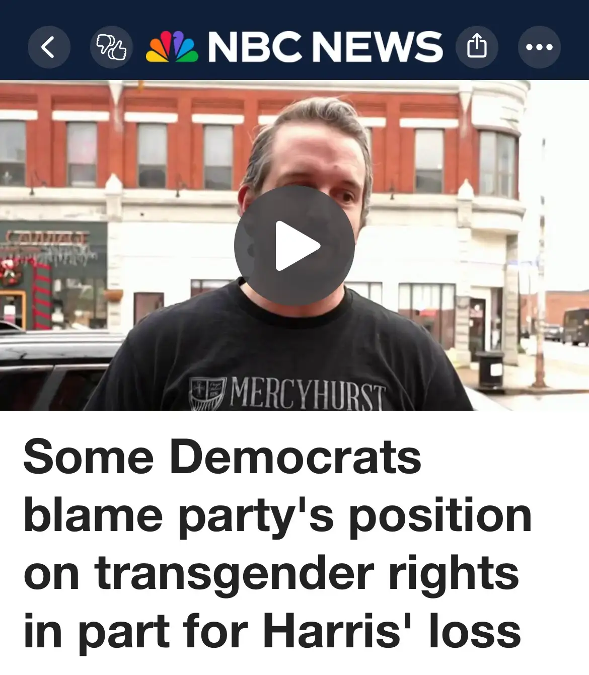 A screenshot of an NBC News video thumbnail shows a man in a black 'Mercyhurst' t-shirt standing outdoors in front of brick…