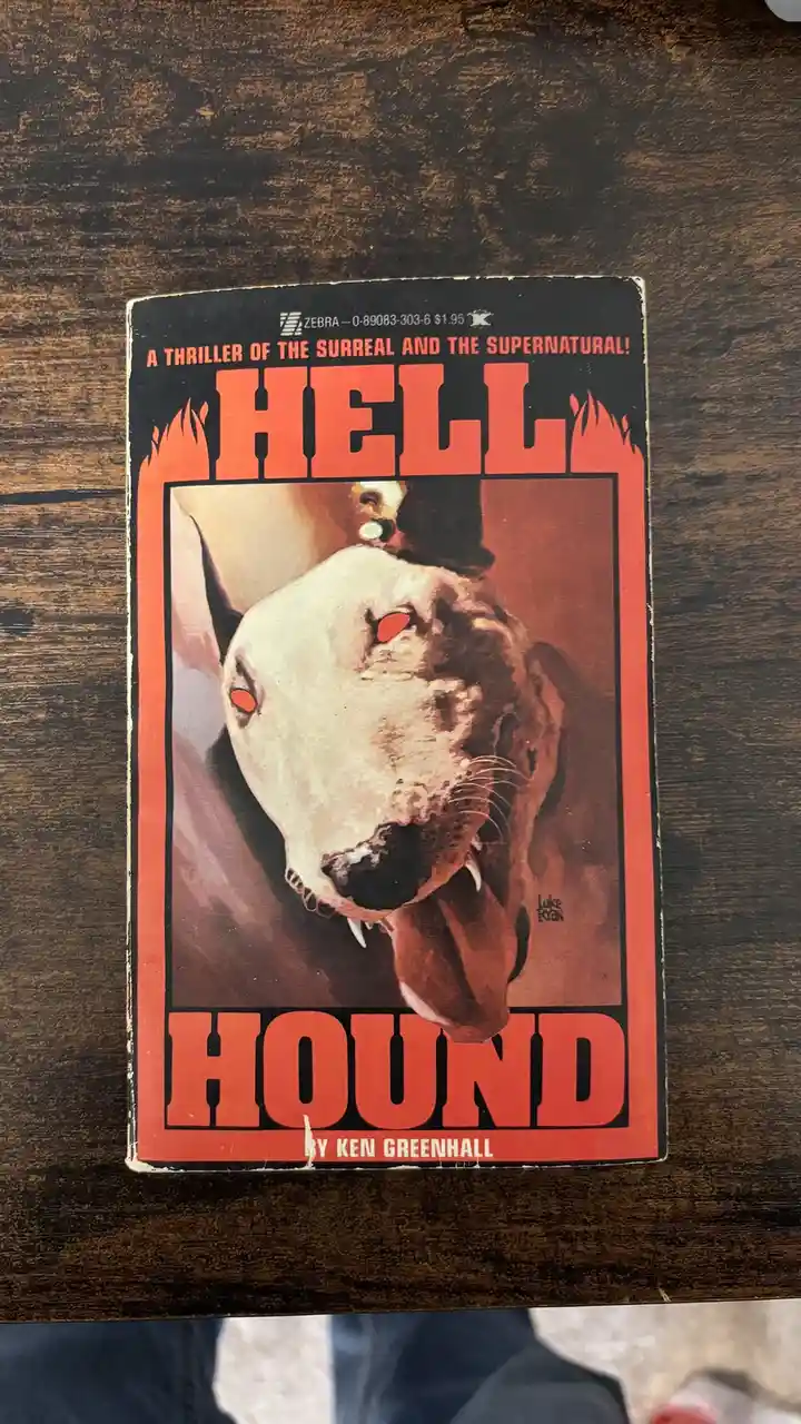 A vintage paperback book titled 'Hell Hound' by Ken Greenhall, featuring a menacing illustration of a dog with glowing red…