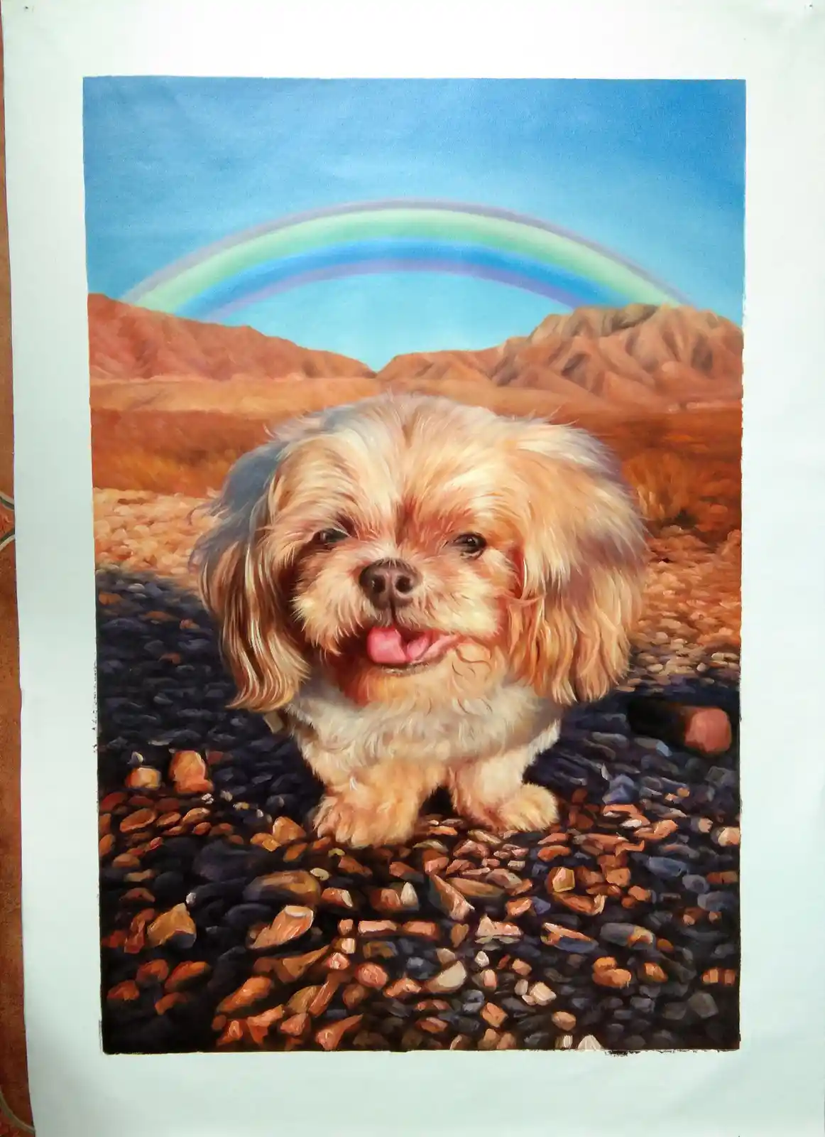 A colorful painting depicts a small, fluffy, light-brown dog with its tongue out, standing on a rocky desert path. Behind…