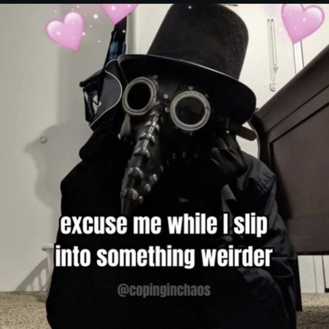 A person wearing a black top hat and a plague doctor mask with a long beak, sitting indoors with pink heart emojis floating…