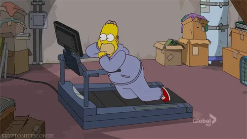 The image shows Homer Simpson in a cluttered basement, struggling on a treadmill. He is wearing a purple sweat suit and red…