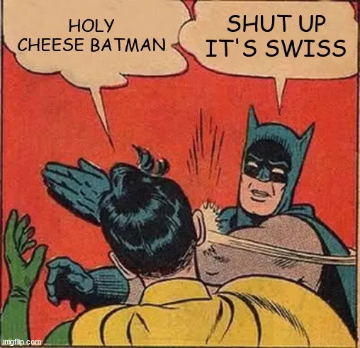 Batman is shown from behind, punching a person in a yellow shirt who is facing away from the viewer. The person being…