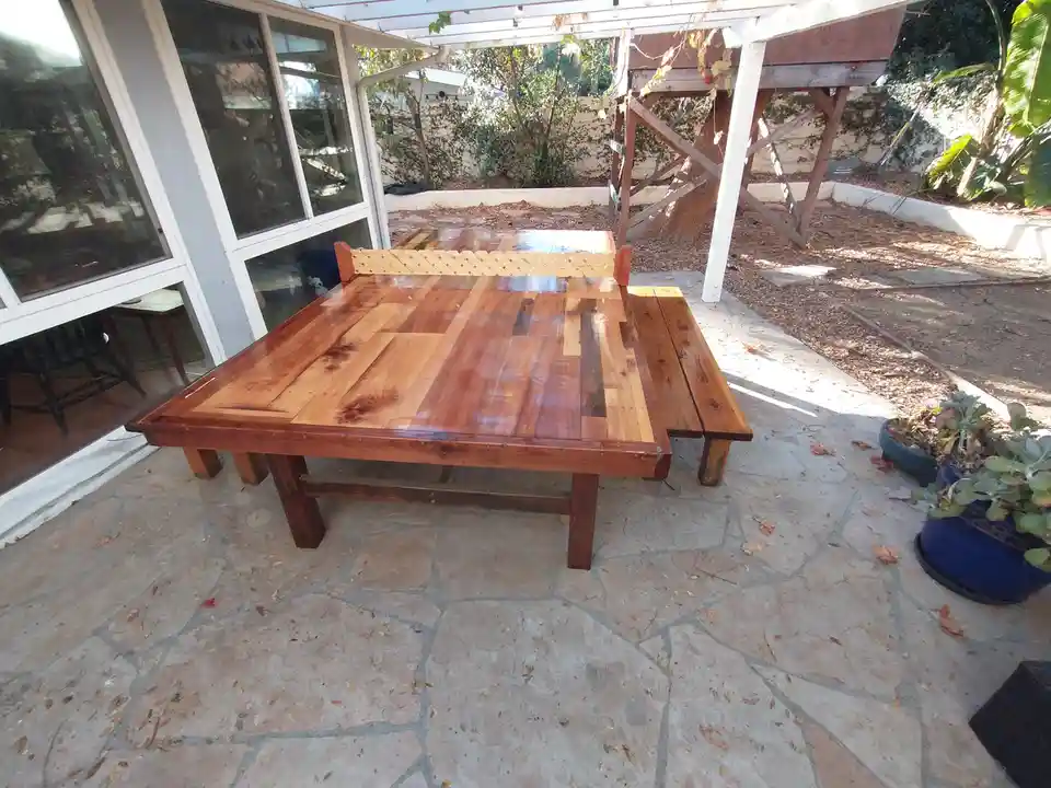 Charming Backyard Setup with Ping Pong and Rustic Benches