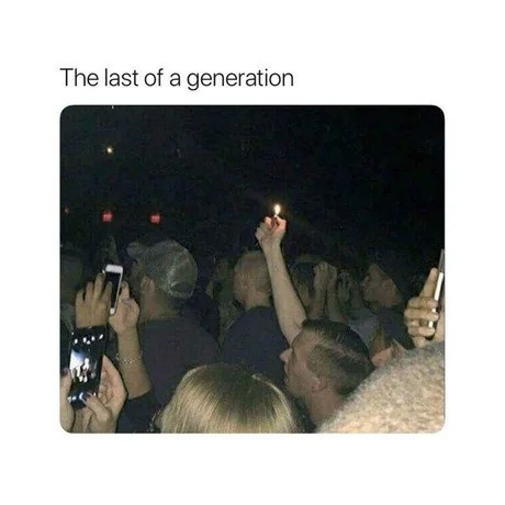 A dimly lit photo shows a crowd of people at night, many holding up smartphones to record the event. One person in the…