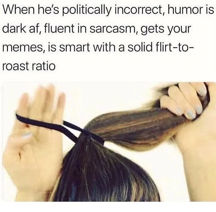A person with long dark hair is shown from behind, holding a black hair tie in one hand and pulling their ponytail taut with…