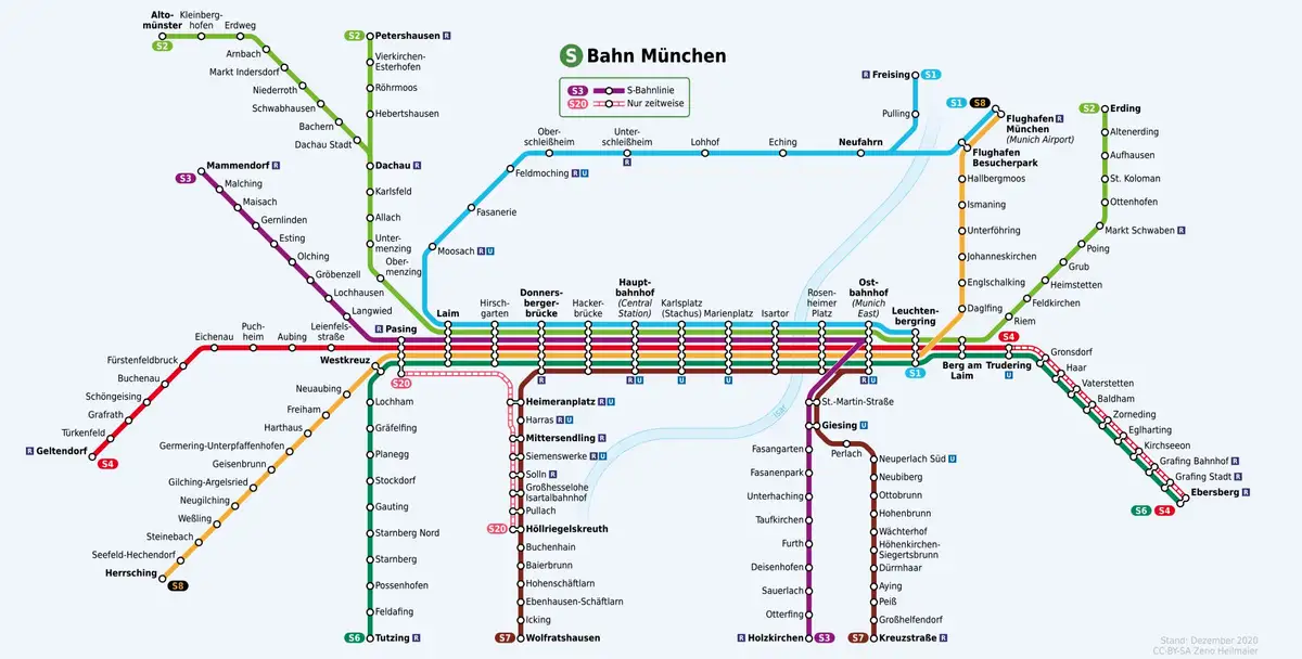 A detailed, colorful map of the Munich S-Bahn rail network showing multiple lines with station names in German, overlaid…