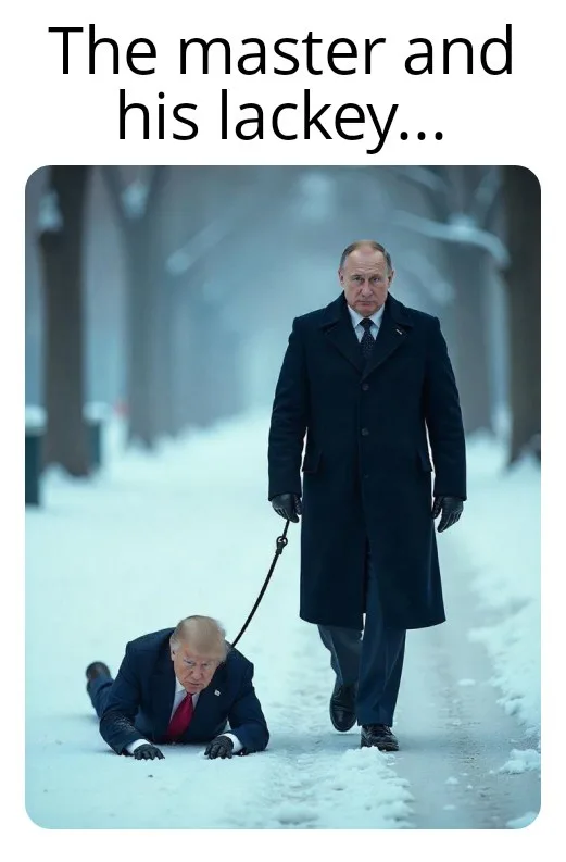 A man in a dark coat walks confidently down a snowy path while holding a leash attached to another man in a suit who is…