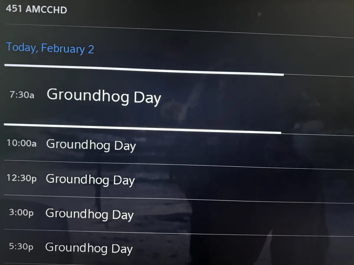 A TV guide screenshot for channel 451 AMCCHD on February 2nd shows the movie 'Groundhog Day' scheduled multiple times…