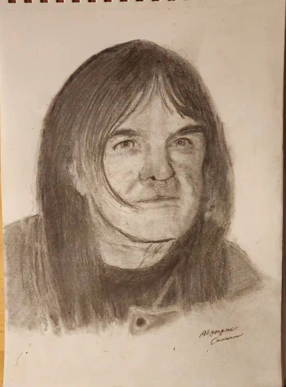 A pencil sketch of a person with long hair and a neutral expression, wearing a collared shirt, with the signature 'Alzogner…