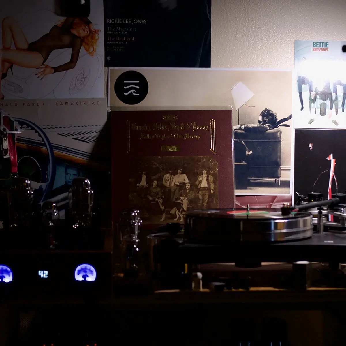 A dimly lit record collection with album covers like Rickie Lee Jones, Donald Fagen, and Crosby, Stills, Nash & Young…