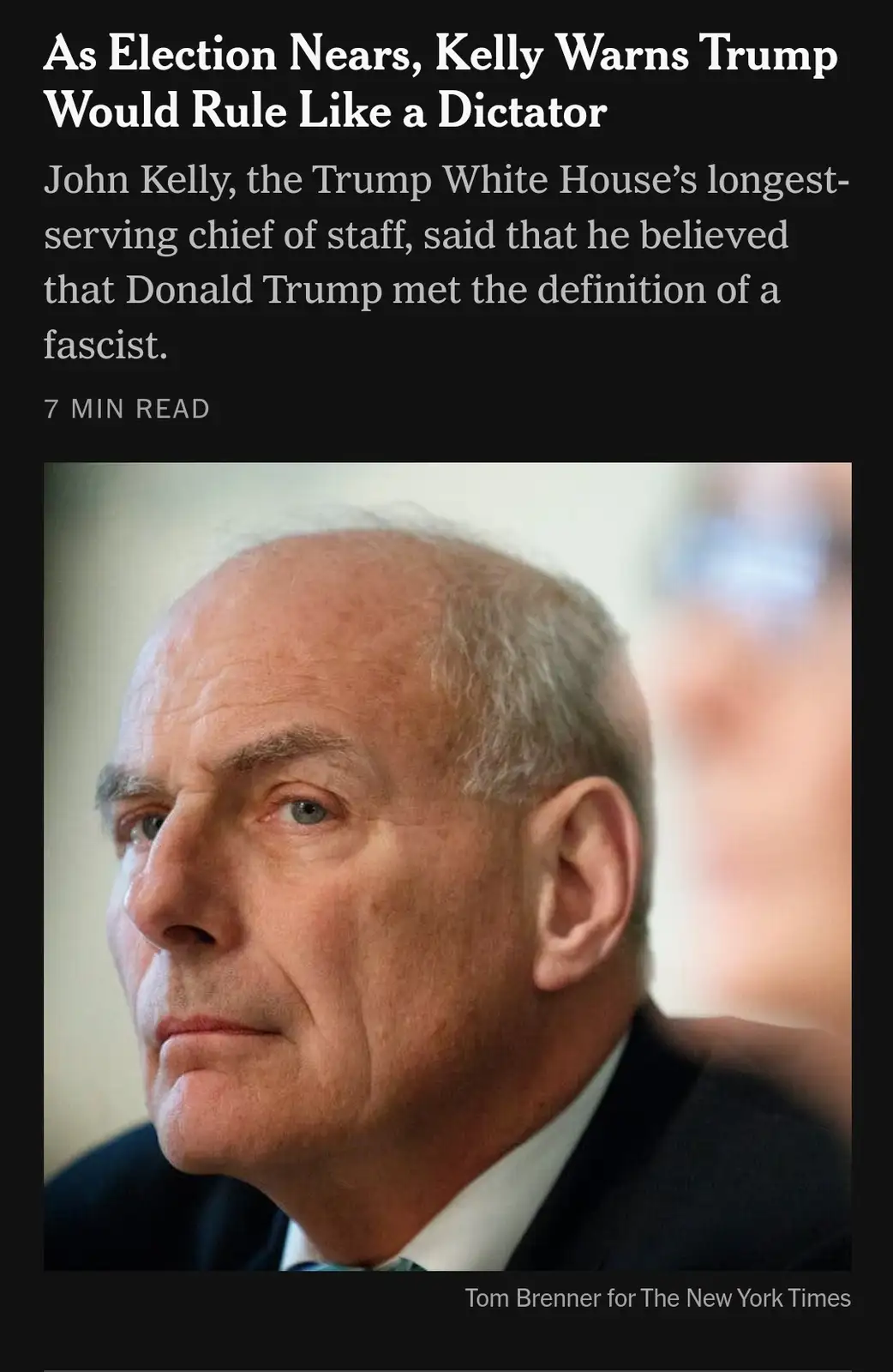 The image shows a close-up of John Kelly, former White House chief of staff, looking serious and pensive. The overlaid text…