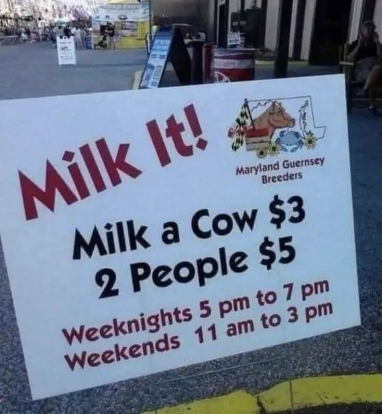 A white sign for 'Maryland Guernsey Breeders' advertises a cow milking experience with prices: $3 for one person, $5 for…