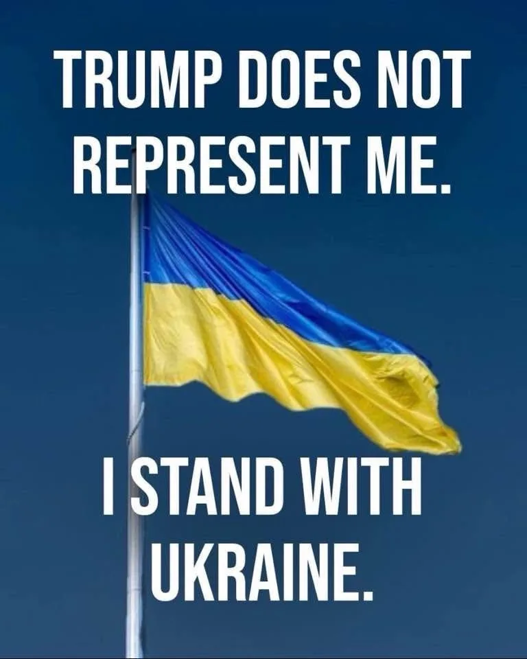 A Ukrainian flag, with its blue and yellow horizontal stripes, waves against a clear blue sky, mounted on a flagpole. White…