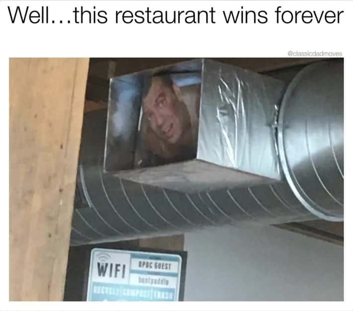 A man's face is visible inside a large, metallic, duct-like ventilation system, looking out with a shocked or amazed…