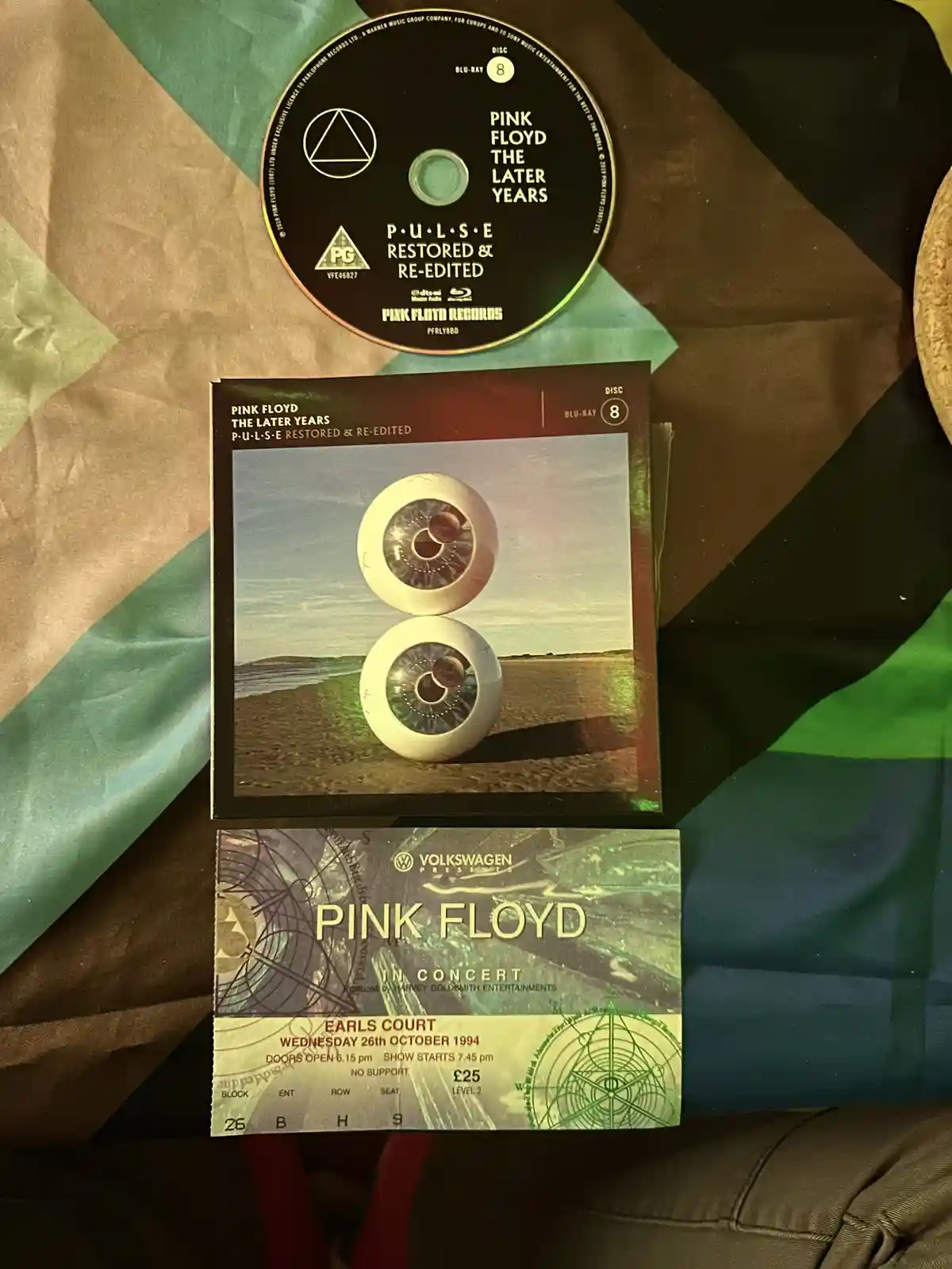 A Pink Floyd Blu-ray disc and case for 'The Later Years: Pulse Restored & Re-Edited' (Disc 8) are stacked above a vintage…