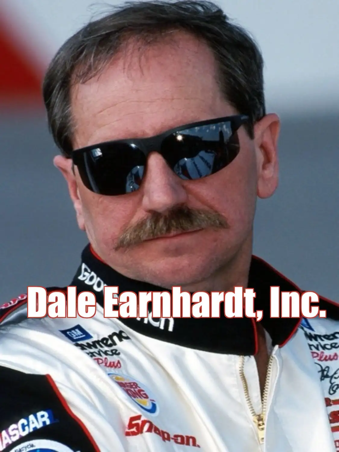 A close-up photo of NASCAR driver Dale Earnhardt wearing sunglasses and a racing suit with sponsor logos like Snap-on and…