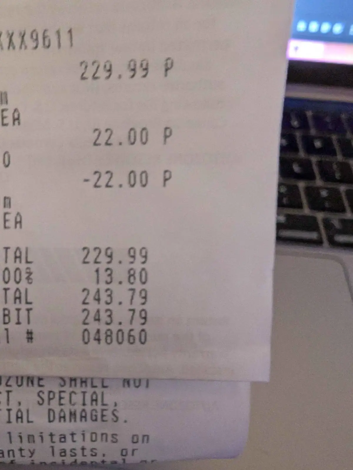 A close-up photo of a receipt showing a subtotal of 229.99, a 22.00 discount applied, and a final total of 243.79, which is…