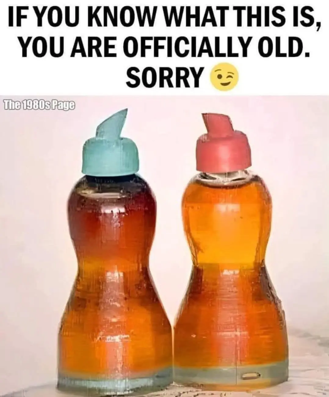 Two vintage-style glass bottles with distinctive hourglass shapes and colored caps—one teal, one red—contain orange liquid…