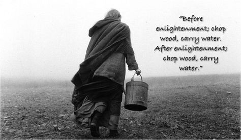 A black-and-white photo shows a person in old-fashioned, layered clothing walking away from the camera across a barren…