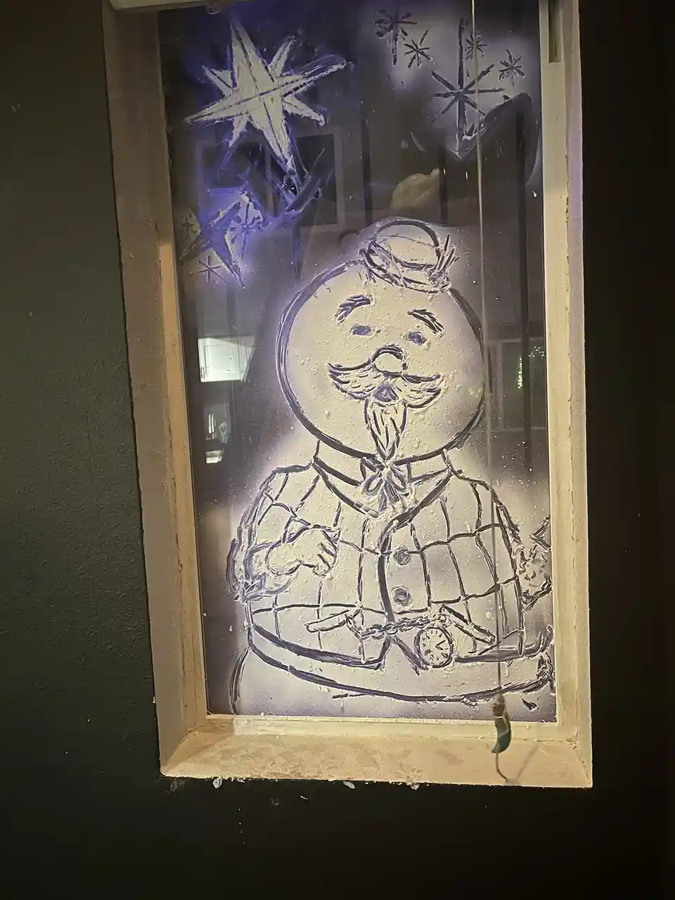 Creative window art featuring Sam the snowman